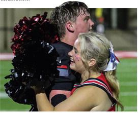 Evan Stasney receives a hug from a Bulldogs cheerleader after GMCP’s win over Glenn Hills. TREY NORRIS/Staff