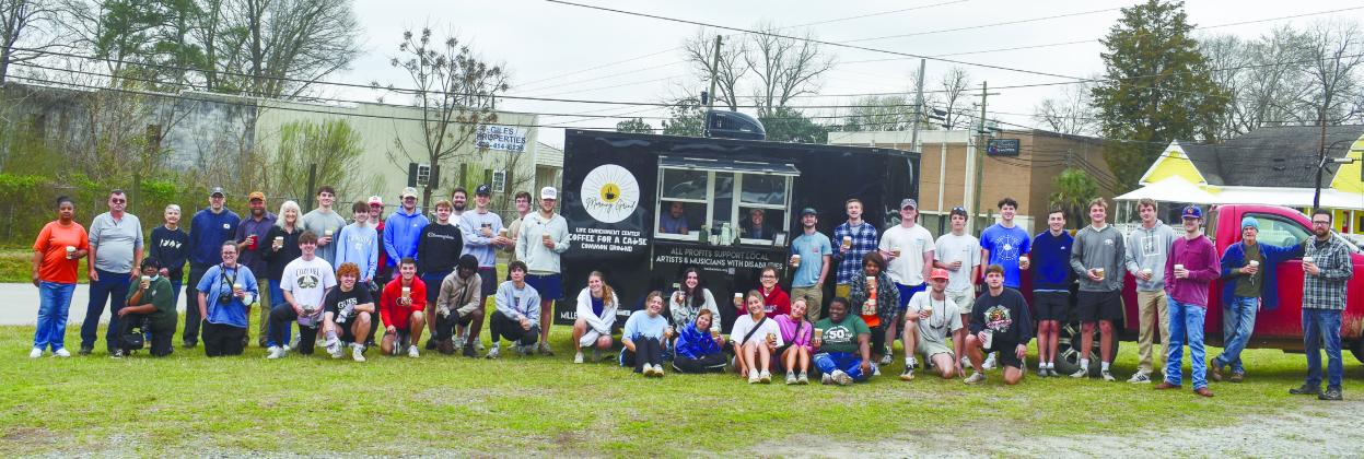 Participants, interns, staff and volunteers with the LEC alongside volunteers from Pi Kappa Alpha, Kappa Alpha Order, Phi Mu and New City Church stand in front of the LEC’s Coffee for a Cause coffee truck.