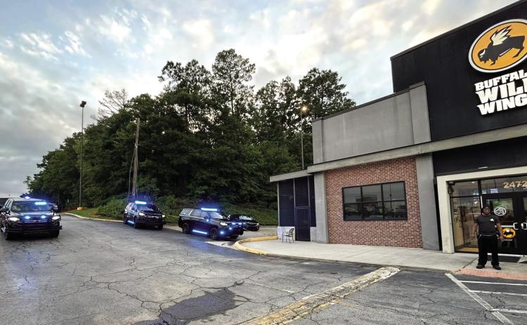 Police gathered around Buffalo Wild Wings after a report of a fight at the establishment ended with shots fired and an employee killed. COURTESY OF MPD