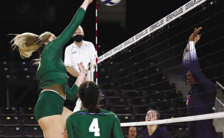 GC volleyball player goes in to spike the ball.