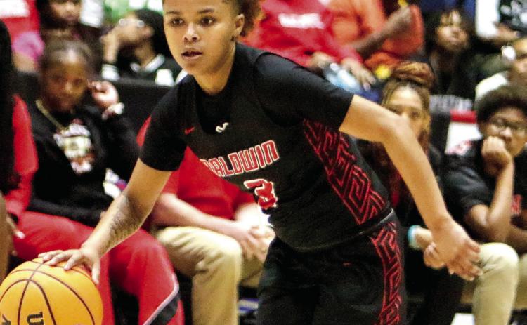 Baldwin sophomore Trinia Lawrence (3) pushes the ball up the floor in transition. LANCE McCURLEY/Staff