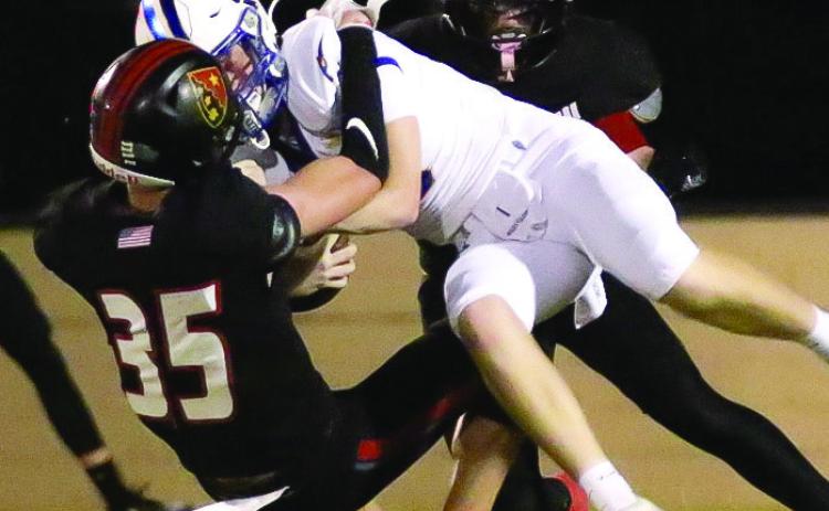 GMC senior Walt Greene (35) hauls down an unidentified ball carrier from a previous game this season. TREY NORRIS/Staff