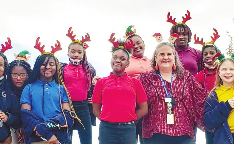 Communities in Schools Site Coordinator for Oak Hill Middle School, Amber Palmer, poses with her students. CONTRIBUTED