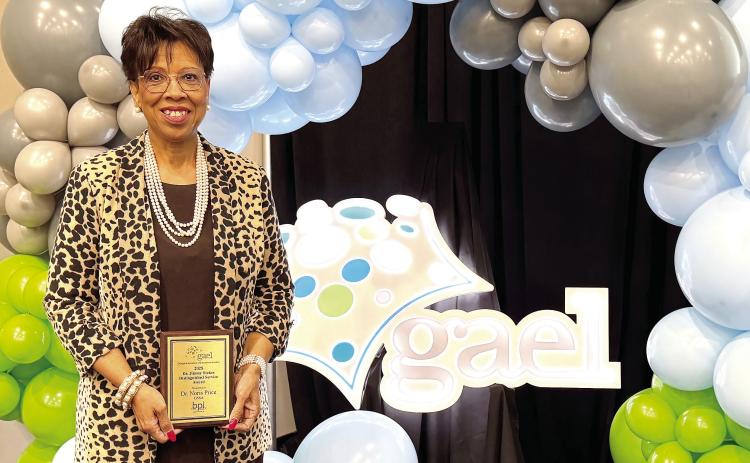 Baldwin County School District Superintendent Dr. Noris Price holds the 2025 Dr. Jimmy Stokes Distinguished Service Award at the Georgia Association for Educational Leaders’ winter conference. CONTRIBUTED