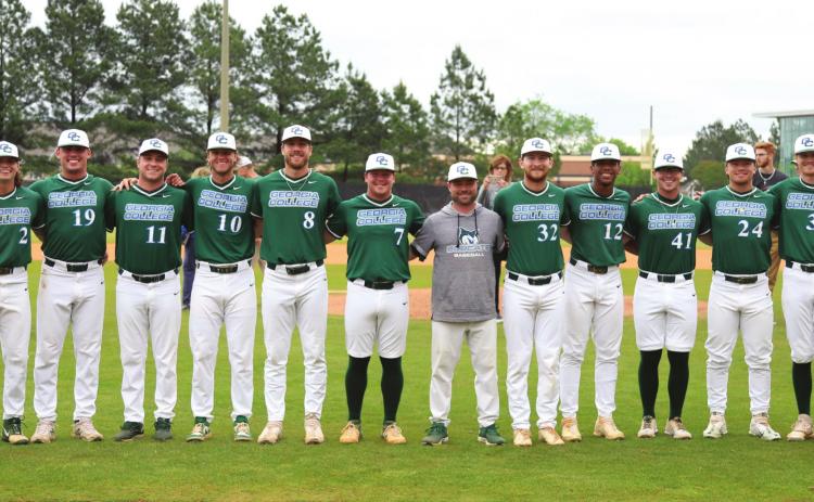 Seniors pose with head coach Nolan Belcher (gray sweatshirt). From left to right: Jacob Hester, Paul Grazzini, Josh Hudgins, Brennan Crooms, KC Brown, Luc Scudellari, Austin Holloway, Sam Sly, Cam Hill, Parker Kauffmann, Baylin Moore, Aidan McAllister, Bryce Bowen. COURTESY OF GC ATHLETICS