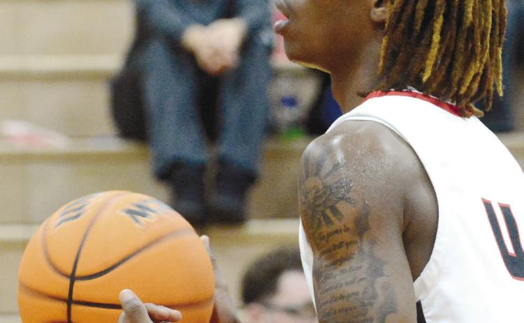 Braves’ Tremarius Lawrence (4) twirls the ball as he gets ready to shoot a free throw in a regular season game earlier in January. BRENDAN KOERNER/Staff