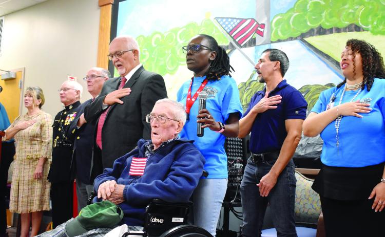 World War II Veteran and Georgia War Veterans Home resident Truett Elton lead the Pledge of Allegiance with staff and special guests repeating it behind him.