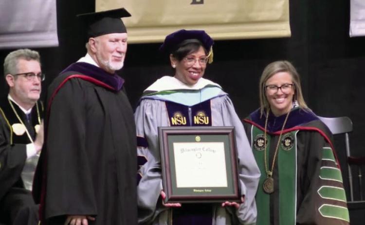 Baldwin County Superintendent Dr. Noris Price (center) holds her honorary Doctorate of Humane Letters after receiving it during Wilmington College’s 148th commencement ceremony. CONTRIBUTED