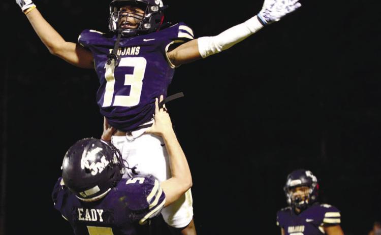 John Milledge Academy quarterback Briggs Eady (5) hoists wide receiver Jalan Butts high in the air after Butts scored JMA’s final touchdown in a record-setting 42-7 win at home Friday night over the Heritage School out of Newnan. SEE FULL COVERAGE >> PAGE C1 IAN TOCHER/Staff