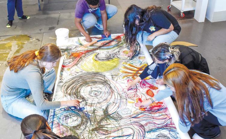 High school students draw during the Sidewalk Chalk Camp hosted by a Georgia Art Education Association high school teacher. Courtesy of ANNA LEAVITT