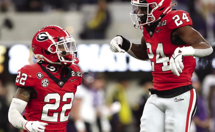Georgia nickel Javon Bullard (22) and safety Malaki Starks (24) celebrate after a turnover. Bullard, a Milledgeville native, caught two interceptions on the way to UGA’s dominant 65-7 win over TCU. SEE FULL STORY >> PAGE C1 COURTESY OF UGA ATHLETICS