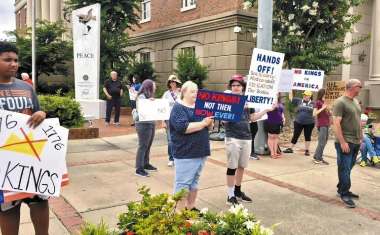 About 30 people gather for a ‘No Kings’ protest in downtown Milledgeville on Saturday, June 14, at the intersection of Hancock and Wilkinson streets. FILE PHOTO