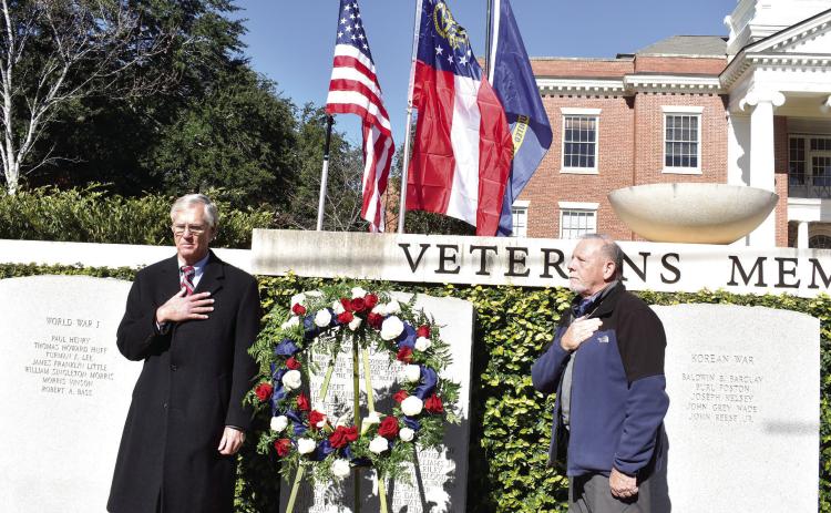 Maj. Gen. Robert C. Hughes Jr. and Retired Commander, U.S.N., Stephen “Bud” Morris lay a wreath on the World War II memorial at the War Veterans Monuments park at Georgia College &amp; State University. BAILEY MCCULLY/Staff