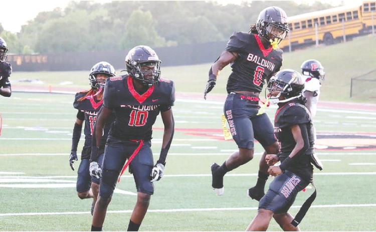 Baldwin players celebrate after a turnover against Washington County on Friday, Sept 8. TREY NORRIS/Staff