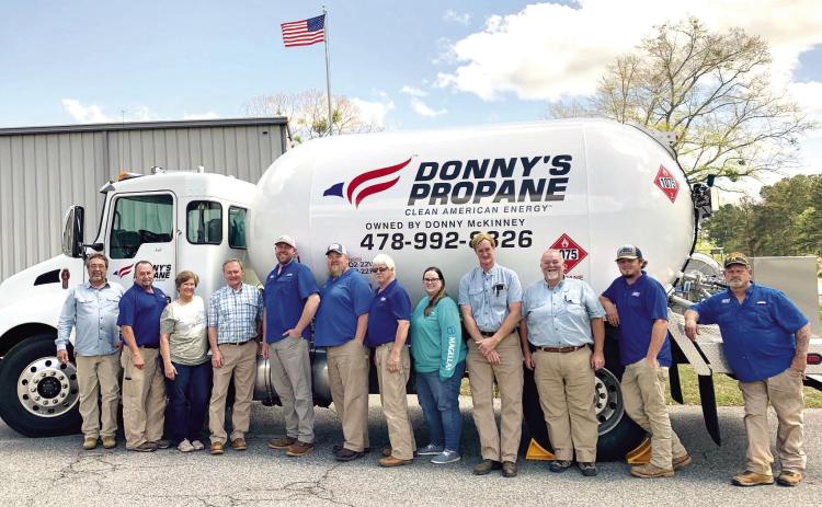 Donny’s Propane employees gather around one of the propane trucks for a photo at the company. ADAM SEGERS/Contributed