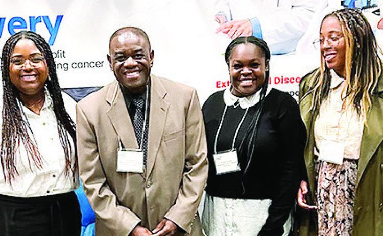 Jasmine Harrison, Dr. Ernie Kaninjing, Christine Hughes and Justine Savizon at the American Cancer Society conference. COURTESY OF GCSU