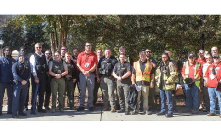 First responders gather outside of Usery Hall at Georgia Military College, after completing three active shooter drill exercises around main campus.