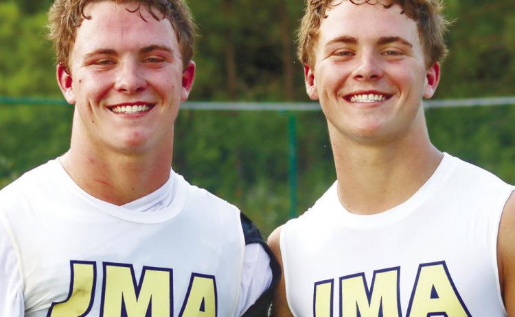 Banks (left) and Briggs Eady before the start of JMA’s season last July. The Trojans went on to finish the season undefeated and win their fourth straight state title. LANCE MCCURLEY/FILE PHOTO