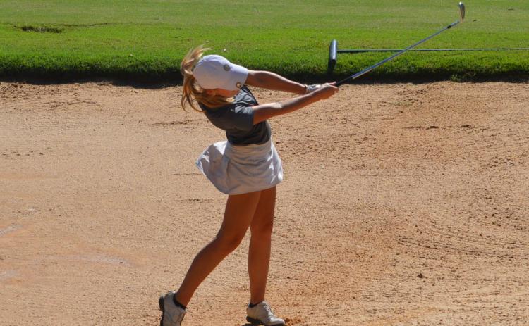 Sadie Natty takes a swing to escape the sand trap. | Contributed
