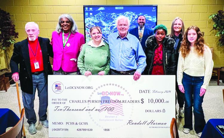 Local author Randall Harman (center) of LetDCKnow.org was joined recently by Putnam County Board of Education Chairman Dr. Steve Weiner (far left) with PCHS faculty and students, as Harman presented prize winnings to students who wrote essays about the 1961 Freedom Riders protests. CONTRIBUTED