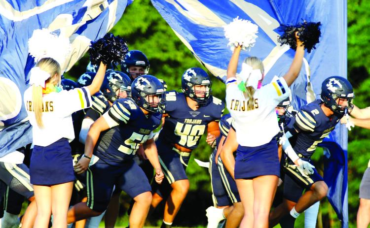 John Milledge Academy’s Trojans take the field for a game played earlier this season at Trojans Field in Milledgeville. TREY NORRIS/Staff