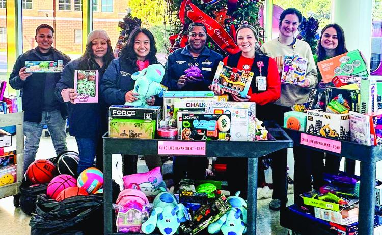 During Car-Mart’s 17th annual Holiday Toy Drive, the dealership collected toys from customers and the community. Showing off the toys are (L-R): General Manager Jae Minor, Office Clerk Maria Perez, Service Advisor Nancy Byrd, Senior Account Representative Jada Simpson, and The Beverly Knight Olson staff: Haleigh Cruce, Jessica Dunkling, and Hannah Robinson. CONTRIBUTED