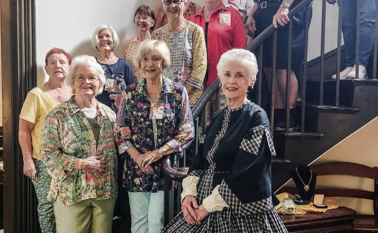 The Carrington Woods Garden Club held its September meeting at the Brown-Stetson-Sandford House. Pictured on the staircase are club members along with host and tour guide Amy Wright (right), who spoke about the rich history of the house afterward the club had lunch in the dining room. CONTRIBUTED