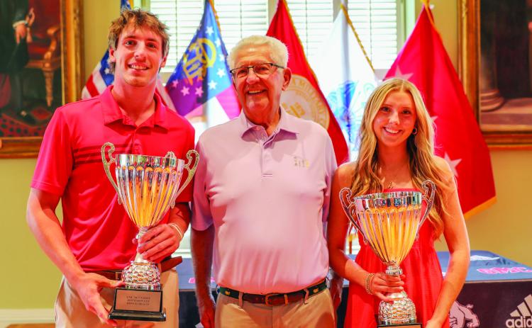 Sophomores Ross Tetrault and Hannah Craig stand with Harold Mason (center) after earning the Mason C up. COURTESY OF GMC
