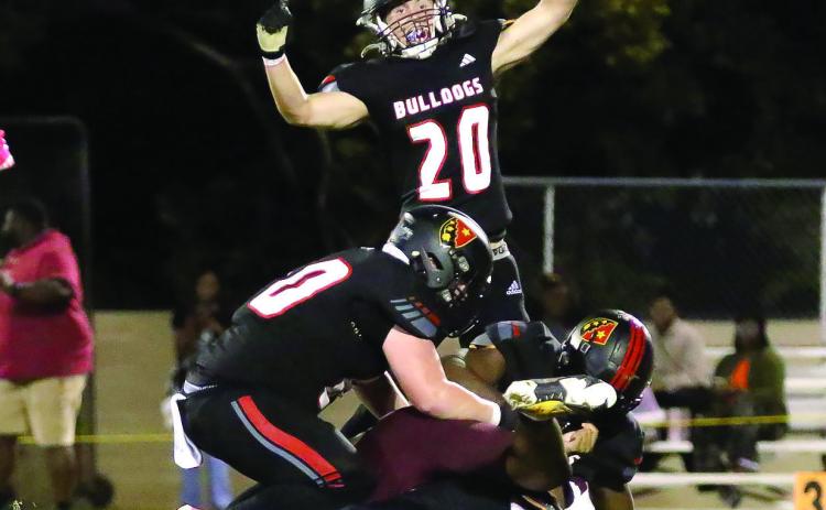 GMC senior Joseph Cox (20) reacts to a tackle by his teammates in a game earlier this season. TREY NORRIS/FILE PHOTO