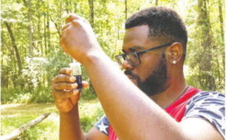 Jodel Nicholas, graduate student in biology, completes chemical training at Tobler Creek. CONTRIBUTED
