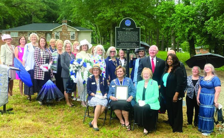 The State of Georgia Society United States Daughters of 1812 pose with the road marker placed on Ft. Wilkinson Road. HANNAH MITCHELL/Staff