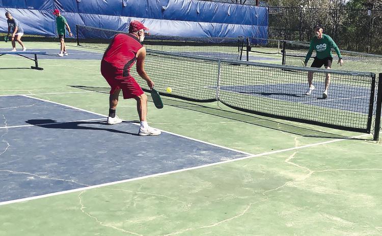 Al Steevens makes a return as Brett Boston waits. Under their feet, the visible cracks are just a few of the many in the courts that Brett Boston hopes can be reapired in the future. GREENEBERRY MOORE/Staff