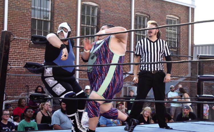 Eddie Honcho (right) defeated Mr. Milledgeville in the first match of WrestleMania. Scan the QR code to view a few highlights of the first two matches. BAILEY BALLARD/Staff