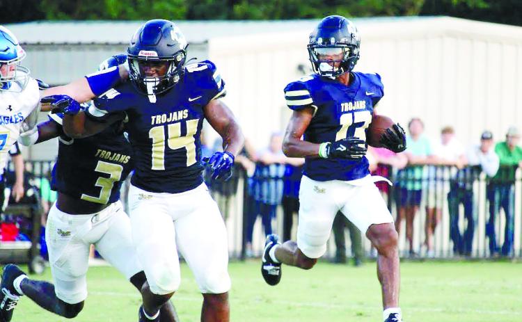 Jalan Butts (13) carries the ball behind blockers Javian Butts (14) and Bud Veal (3) during a JMA home game earlier this season.