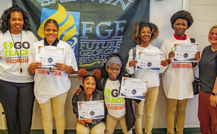 (L–R): Teaching Pathway Instructor TeQuila Thomas, Breonia Bolston, Tameriana Reese, Sanaa Gillam, Madison Smith, Benjamin Campbell, and Victoria Morris (senior and pathway completer). CONTRIBUTED