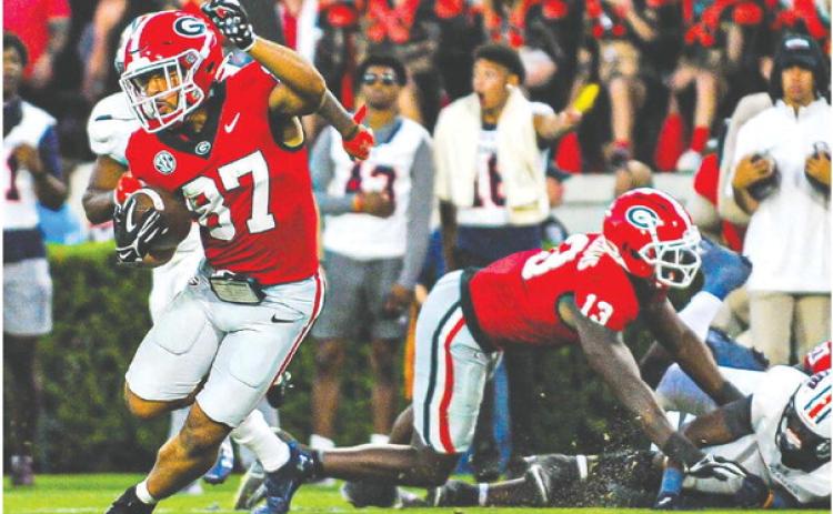 Georgia wide receiver Mehki Mews (87) breaks away from defenders on a 54-yard touchdown during Saturday’s win over UTMartin. CHARLES JORDAN/Contributed