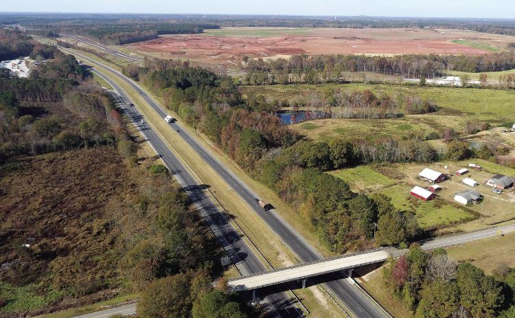 A new interchange will be constructed at I-20 and Old Mill Road, leading to a large frontage road for the Rivian electric vehicle manufacturing plant. Site grading work is visible in the background. MARK ENGEL/Staff