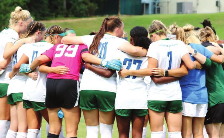 GC Soccer huddles pregame. COURTESY OF GC ATHLETICS
