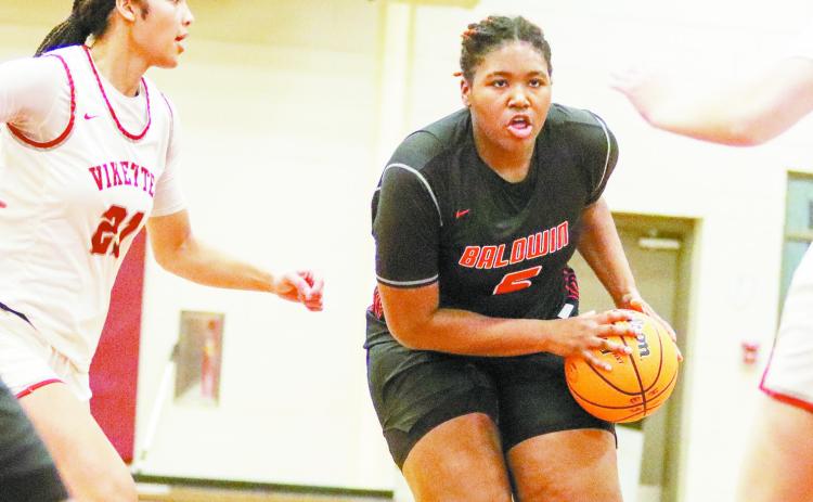 Baldwin junior power forward Janaye Walker (5) drives the lane against Lowndes County in Monday’s 75-50 rout of the Lady Vikings. LANCE MCCURLEY/Staff