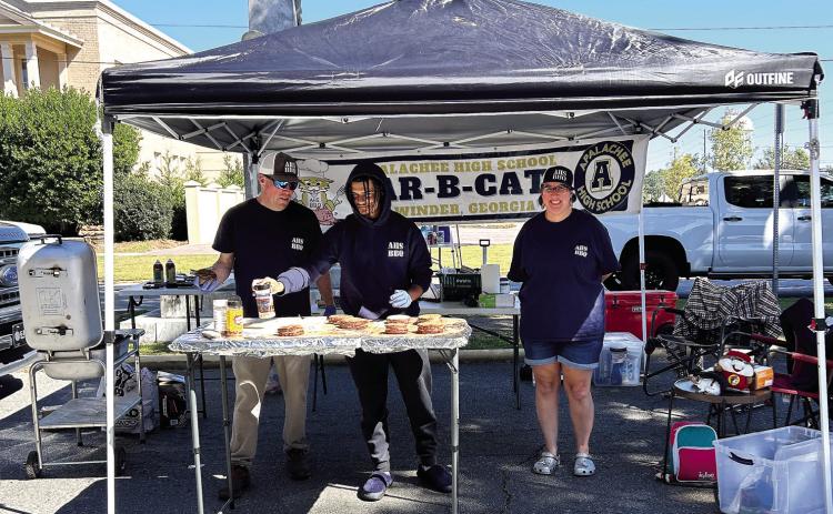 BAR-B-CATS, representing Apalachee High School, attempts to win first place in their third annual Steak-Off at Deep Roots. HUDSON TAYLOR/Staff