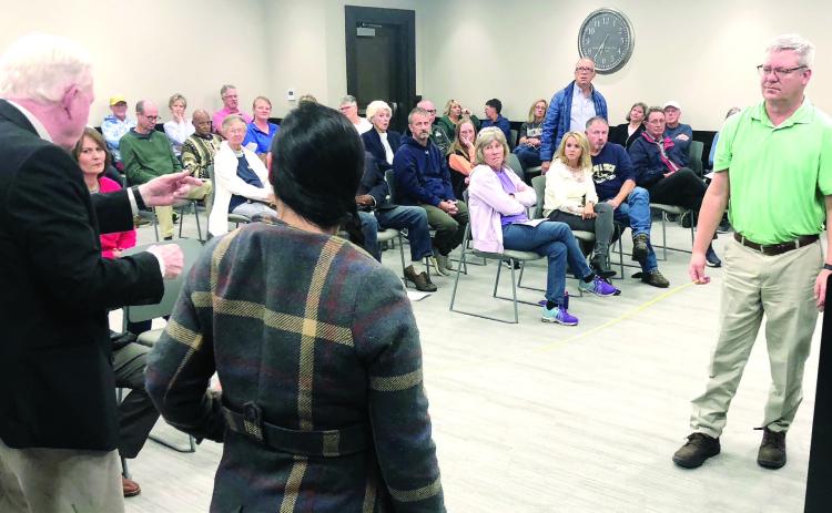 County commissioner Henry Craig (left) uses a tape to demonstrate the narrow distance between proposed Pickleball courts. GREENBERRY MOORE/Staff