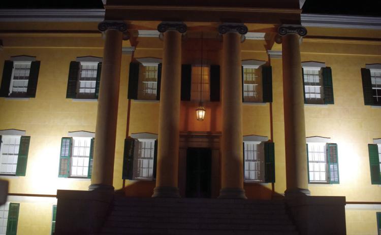 Georgia’s Old Governor’s Mansion dimly lit during the night welcoming guest into its candle-lit halls for the Death After Dark tour. BAILEY BALLARD/Staff