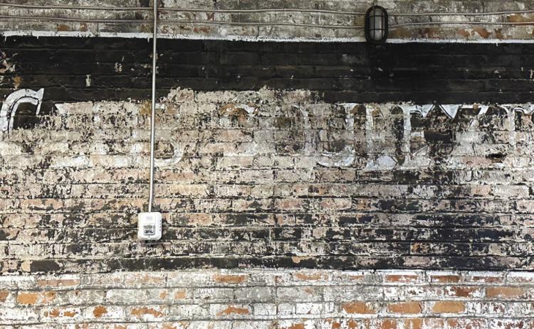The faded sign for Club Squeeze remains on the wall as a lesson about a person’s journey. CONTRIBUTED