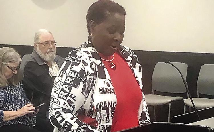 Latonya Howell reads a speech highlighting the history of women in Milledgeville and Baldwin County who have worked in public service. BAILEY MCCULLY/Staff