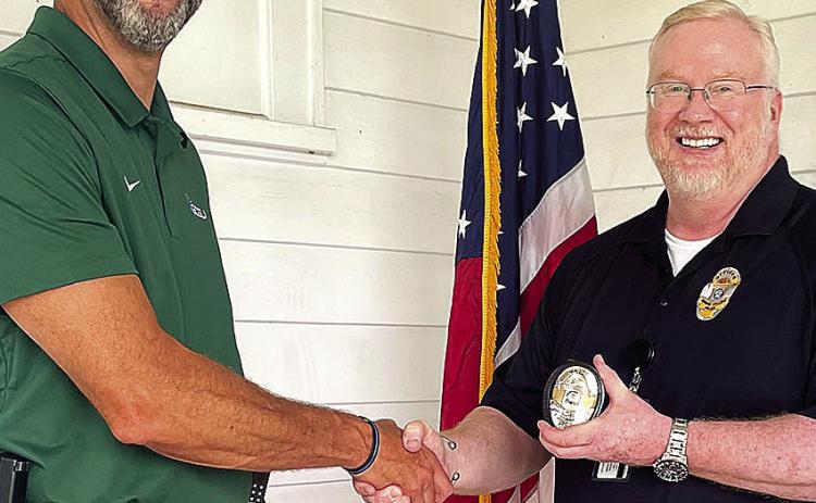 Major Brian Freese (right) took the oath of office from Chief of Police Wes Hardin on the front porch of Georgia College’s Hall House. COURTESY OF GCSU