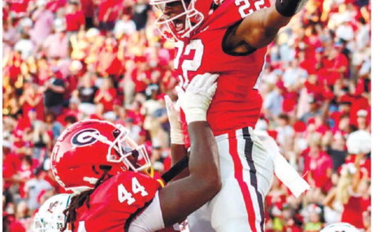 Georgia freshman running back Branson Robinson (22) got his first touchdown in Sanford Stadium Saturday against the Auburn Tigers. He was also the leading rusher in the game. LANCE McCURLEY/Staff