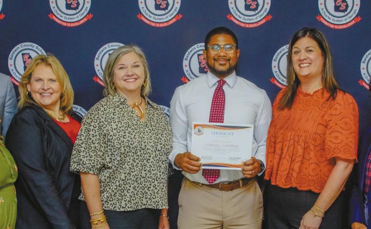 The Baldwin County Board of Education, Baldwin County Superintendent Kristina Brooks (black suit), Baldwin County Assistant Superintendent Dr. Rodney Tyson (far right), and Lakeview Academy Principal Cory Roberson (center) stand together with the Certificate of Recognition. CONTRIBUTED
