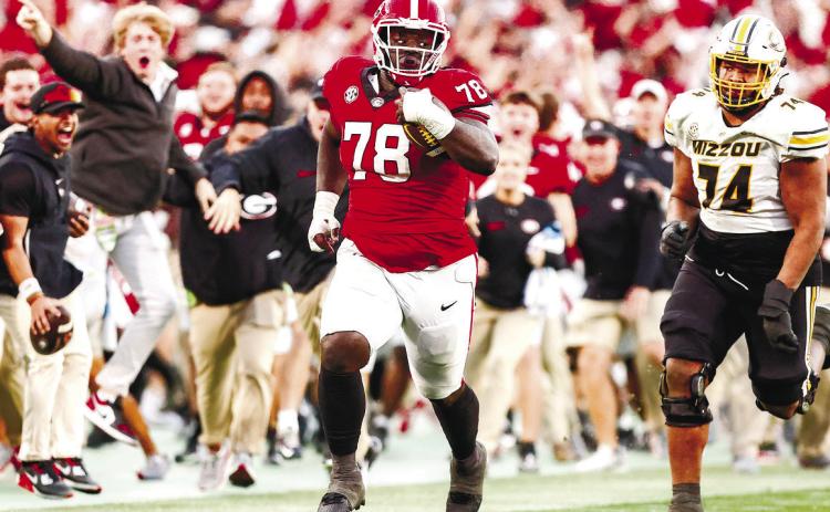 Georgia defensive lineman Nazir Stackhouse (78) returns an interception in the fourth quarter during Georgia’s game against Missouri on Dooley Field at Sanford Stadium Nov. 4 in Athens. TONY WALSH/UGA Athletics