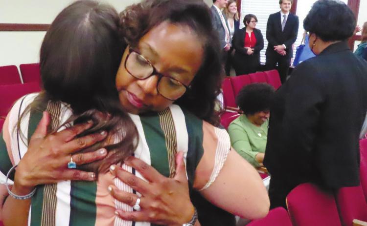 Denise Billue, sister of murder victim Sgt. Curtis Billue, hugs Putnam County Victim’s Advocate Kristen Dupree after the sentencing. COURT POOL COVERAGE