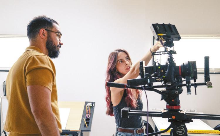 Haley Fusia’s knowledge learned from Georgia Film Academy courses shines as she collaborates with the director on an actor’s entrance. HALEY FUSIA/Contributed